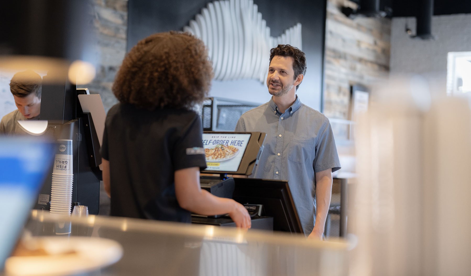 man ordering at California Fish Grill