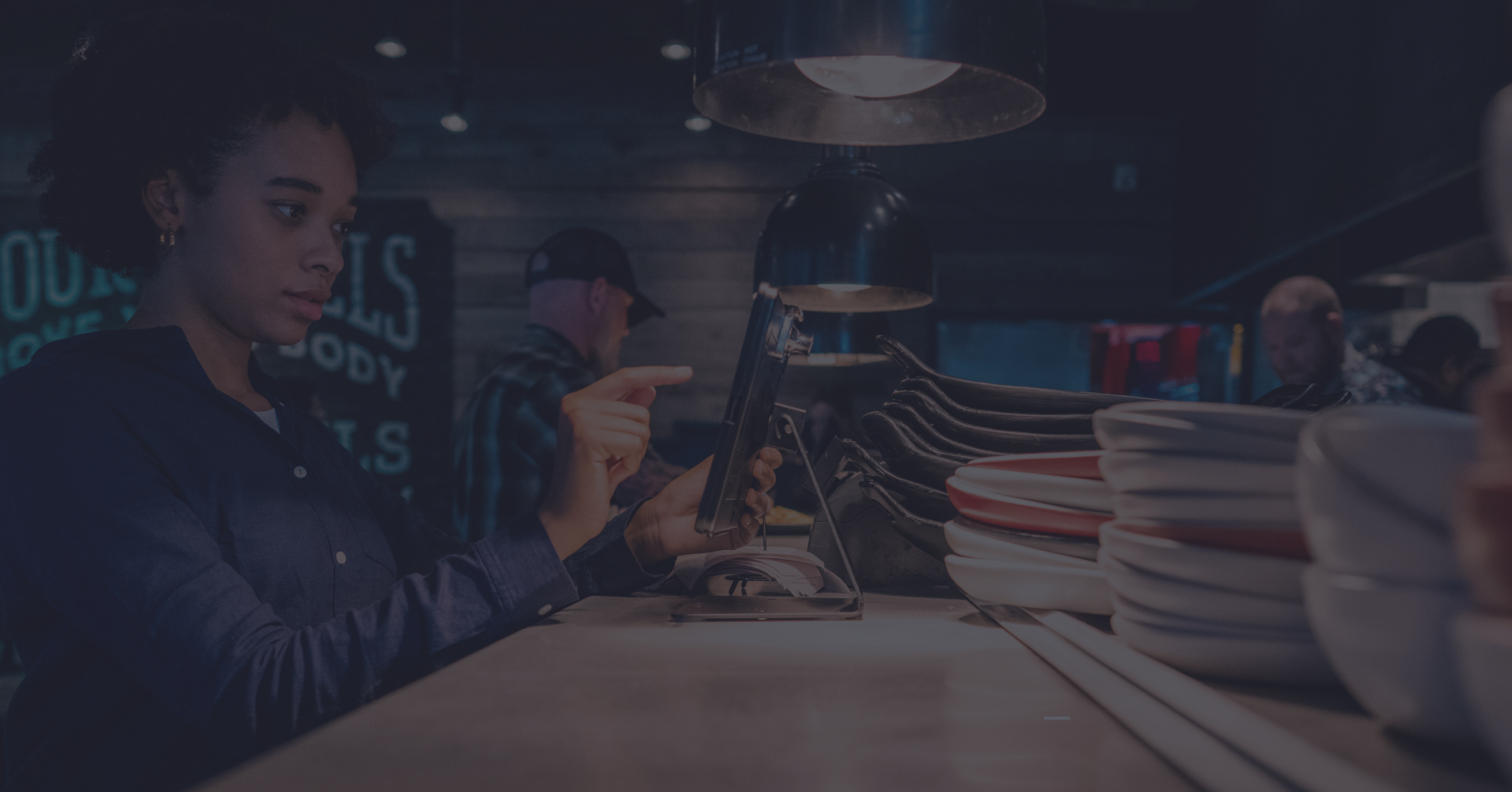 restaurant employee looking at kiosk